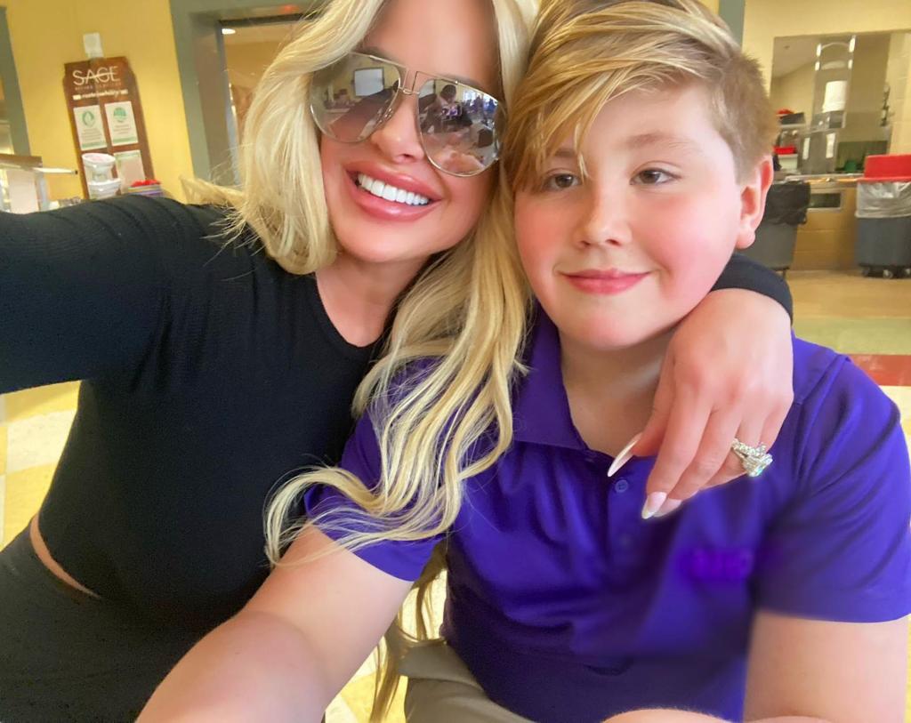 Kash Kade and Kim Zolciak pose together.