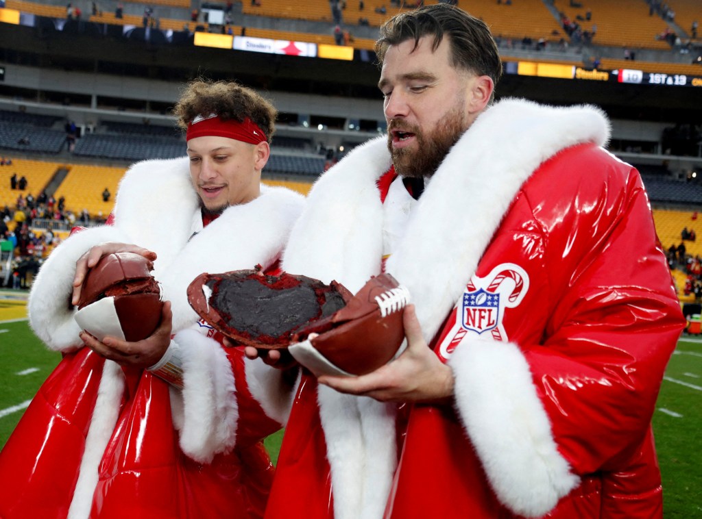 Patrick Mahomes and Travis Kelce holding Netflix's football cake after their Kansas City Chiefs game on Christmas Day Wednesday. 