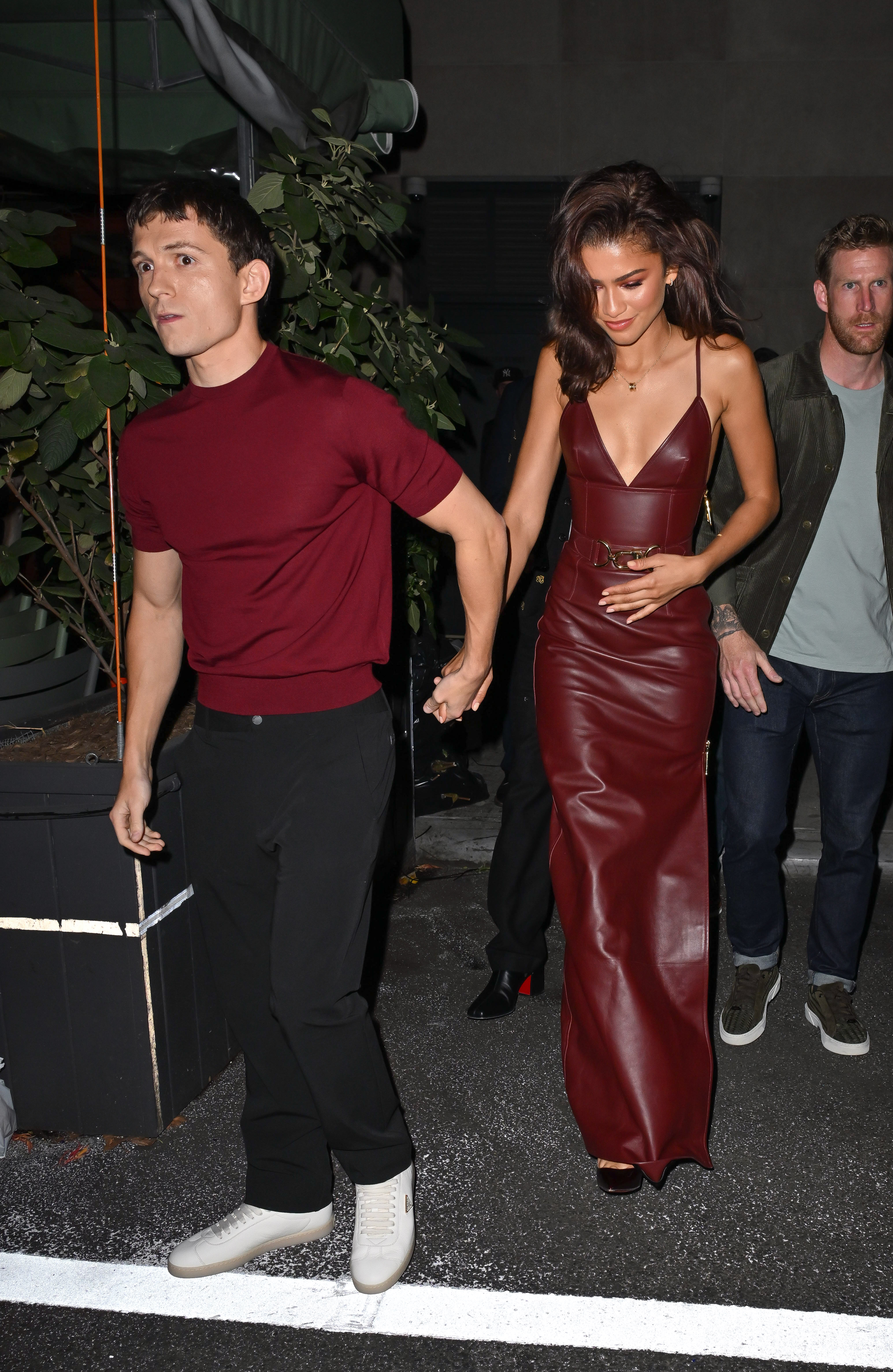 Tom Holland and Zendaya holding hands while leaving the Corner Bar in October 2024.