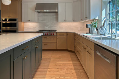 Example of a large transitional l-shaped light wood floor and brown floor eat-in kitchen design in San Francisco with an undermount sink, shaker cabinets, light wood cabinets, quartz countertops, white backsplash, subway tile backsplash, stainless steel appliances, an island and white countertops