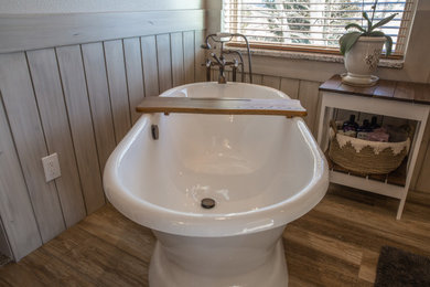 Example of a small mountain style master subway tile porcelain tile, gray floor, single-sink and wainscoting bathroom design in Denver with shaker cabinets, brown cabinets, a two-piece toilet, beige walls, a vessel sink, quartz countertops, a hinged shower door, beige countertops and a built-in vanity