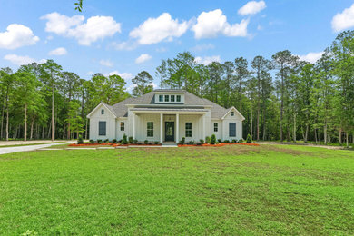 Farmhouse one-story concrete fiberboard exterior home photo in New Orleans with a shingle roof