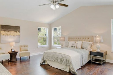 Large elegant master dark wood floor, brown floor and vaulted ceiling bedroom photo in Detroit with white walls