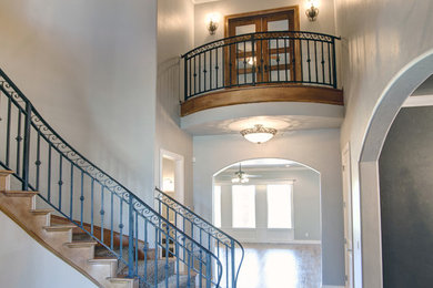 Example of a huge trendy foyer design in Oklahoma City with gray walls