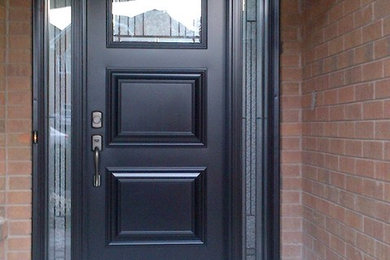 Inspiration for an entryway remodel in Toronto with a black front door