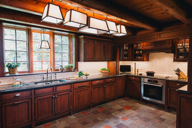 Large mountain style u-shaped slate floor eat-in kitchen photo in Boston with no island, beaded inset cabinets, dark wood cabinets, granite countertops, white backsplash, subway tile backsplash, stainless steel appliances and a double-bowl sink