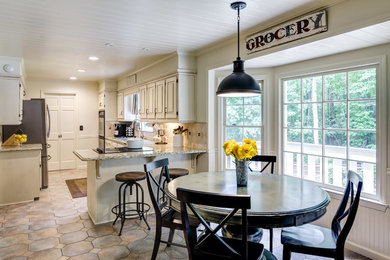 Mid-sized farmhouse eat-in kitchen photo in Atlanta with granite countertops and beige backsplash