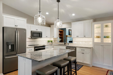 Inspiration for a light wood floor kitchen remodel in Minneapolis with an undermount sink, shaker cabinets, turquoise cabinets, granite countertops, ceramic backsplash and an island