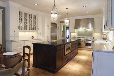 Inspiration for a large transitional terra-cotta tile eat-in kitchen remodel in Nashville with a farmhouse sink, white cabinets, quartz countertops, white backsplash, subway tile backsplash, stainless steel appliances, an island and recessed-panel cabinets
