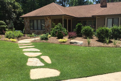 Inspiration for a mid-sized traditional full sun front yard stone landscaping in Atlanta for spring.