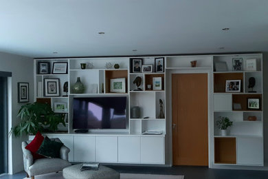 Example of a large minimalist open concept living room design with a wall-mounted tv
