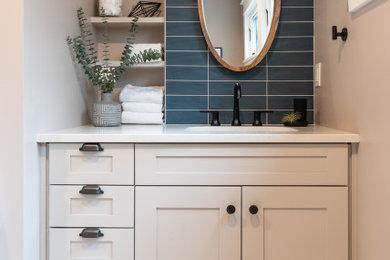 Inspiration for a mid-sized transitional blue tile and subway tile ceramic tile and white floor powder room remodel in Seattle with shaker cabinets, white cabinets, a two-piece toilet, gray walls, an undermount sink, quartz countertops, white countertops and a built-in vanity