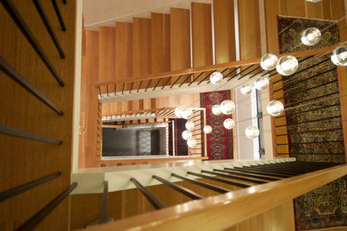 Example of a trendy wooden floating staircase design in Seattle