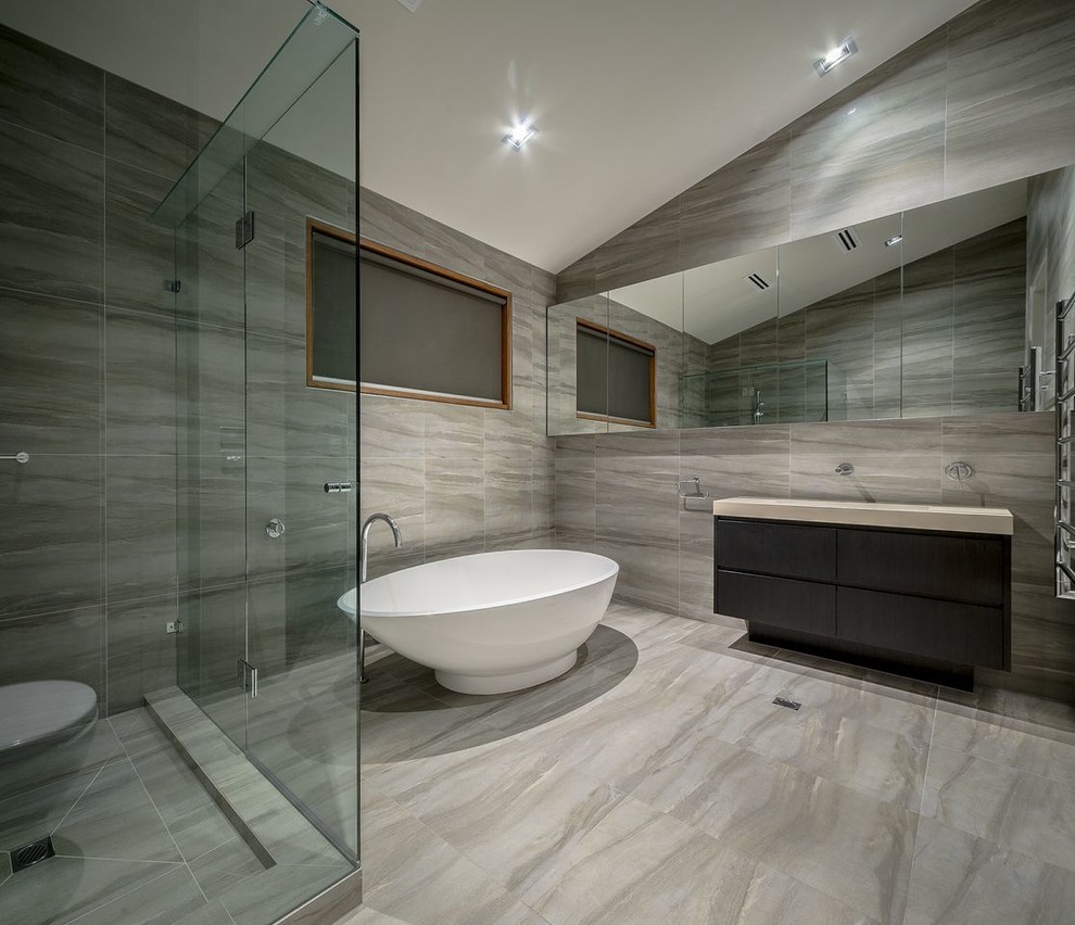 Example of a mid-sized trendy master porcelain tile porcelain tile bathroom design in Melbourne with a one-piece toilet, a drop-in sink, flat-panel cabinets, dark wood cabinets and a hinged shower door