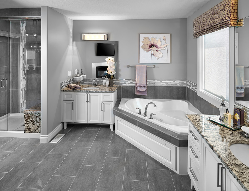 Example of a transitional gray tile and ceramic tile bathroom design in Edmonton with an undermount sink, recessed-panel cabinets and white cabinets
