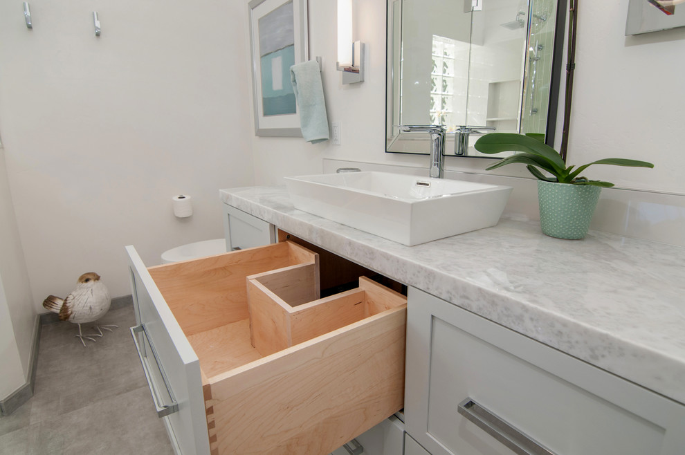 Example of a large transitional master white tile and porcelain tile porcelain tile and gray floor bathroom design in San Diego with shaker cabinets, gray cabinets, white walls, a vessel sink, marble countertops, a one-piece toilet and a hinged shower door