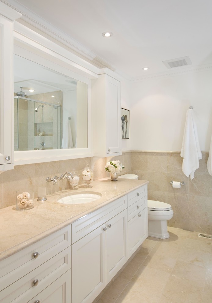 Mid-sized elegant 3/4 beige tile and ceramic tile beige floor bathroom photo in Ottawa with an undermount sink, recessed-panel cabinets, white cabinets, a one-piece toilet, white walls and beige countertops