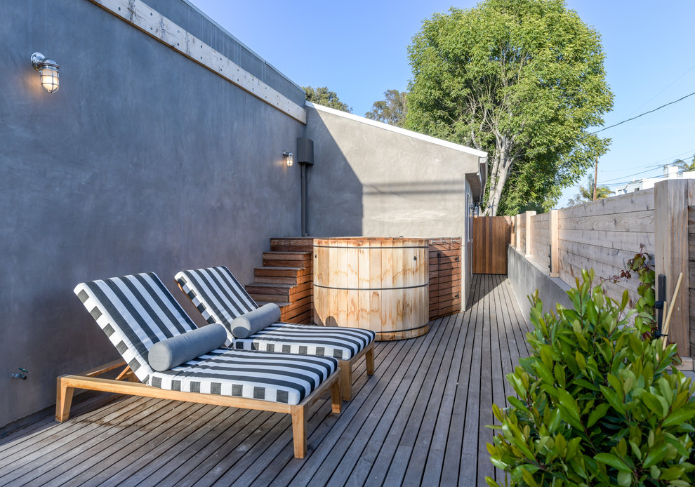 Example of a beach style side yard deck design in Los Angeles with no cover