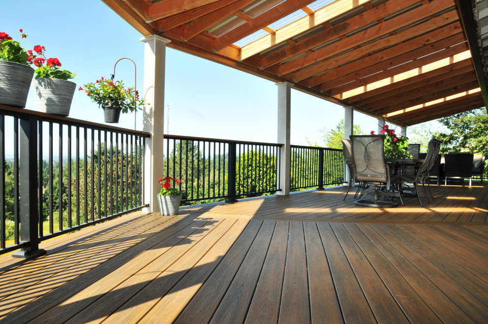 Large trendy backyard second story metal railing deck photo in Portland with an awning