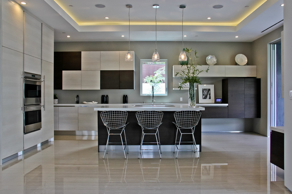 Eat-in kitchen - large contemporary l-shaped porcelain tile eat-in kitchen idea in Los Angeles with flat-panel cabinets, light wood cabinets, stainless steel appliances, an undermount sink and an island
