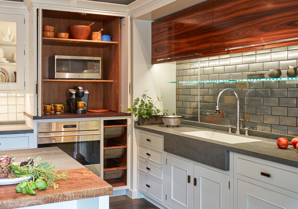 Mid-sized transitional l-shaped dark wood floor and brown floor enclosed kitchen photo in Chicago with flat-panel cabinets, quartz countertops, porcelain backsplash, an island, gray countertops, an undermount sink, medium tone wood cabinets, metallic backsplash and stainless steel appliances