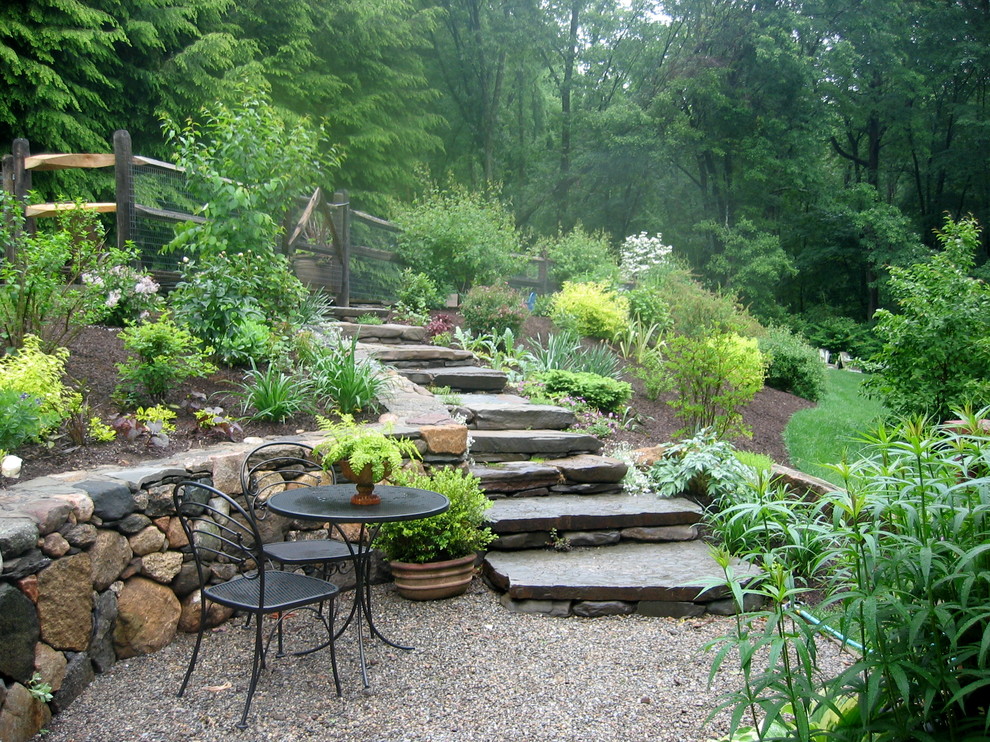 Photo of a rustic backyard retaining wall landscape in New York.