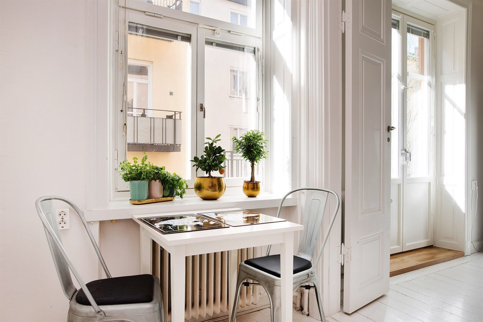 Kitchen/dining room combo - mid-sized scandinavian painted wood floor kitchen/dining room combo idea in Stockholm with white walls and no fireplace
