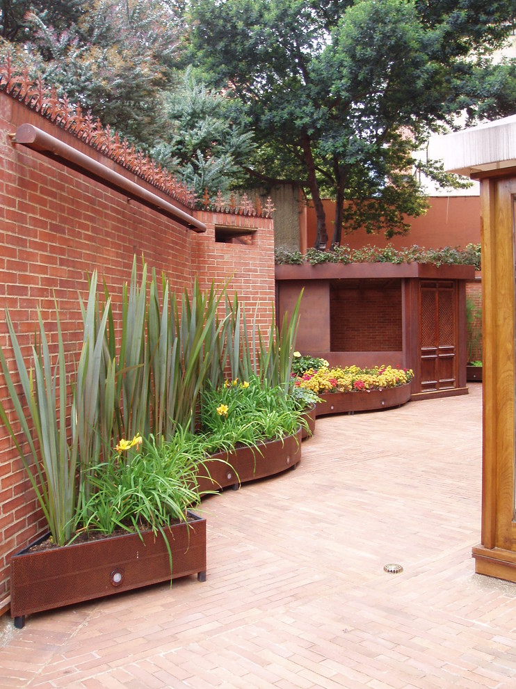 Inspiration for a contemporary patio in London with brick paving.