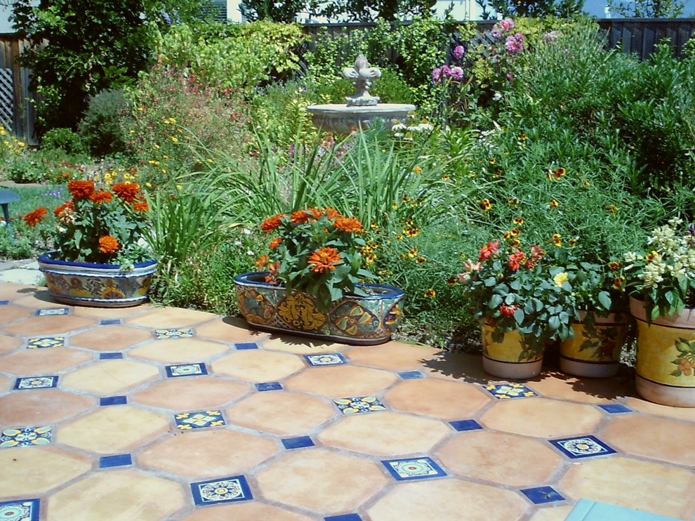 Large tuscan courtyard tile patio fountain photo in Sacramento with no cover