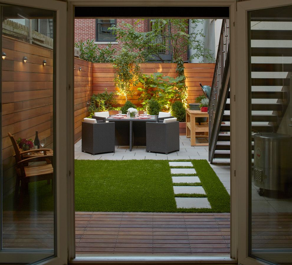 Trendy backyard concrete paver patio photo in New York with no cover