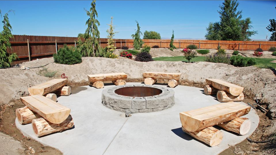 Patio - large rustic backyard concrete patio idea in Seattle with a fire pit and no cover