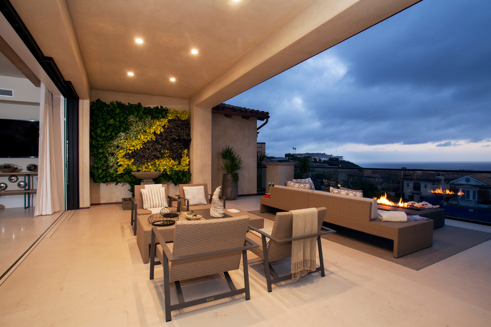 Patio - contemporary patio idea in Orange County with a fire pit and a roof extension