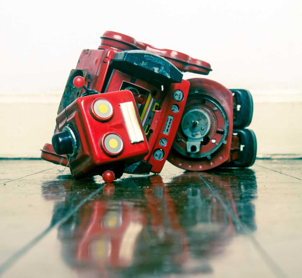 robot wars red robot defeated on old wooden floor