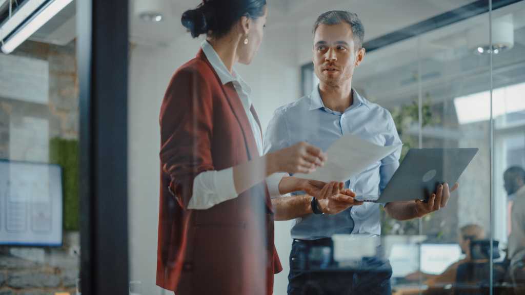 CEO and Chief Executive Talking About Company Business Growth, Consult Data Analysis and Use Laptop Computer. Two Professionals Discussing Revenue Increase, Market Disruption, Planning Strategy