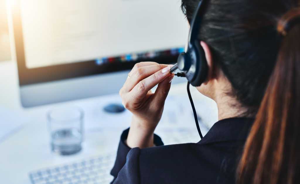 Woman, headset and call center in office, crm and customer service for conversation and online support. Computer, telemarketing and consultant for career, operator and female person for hotline agent