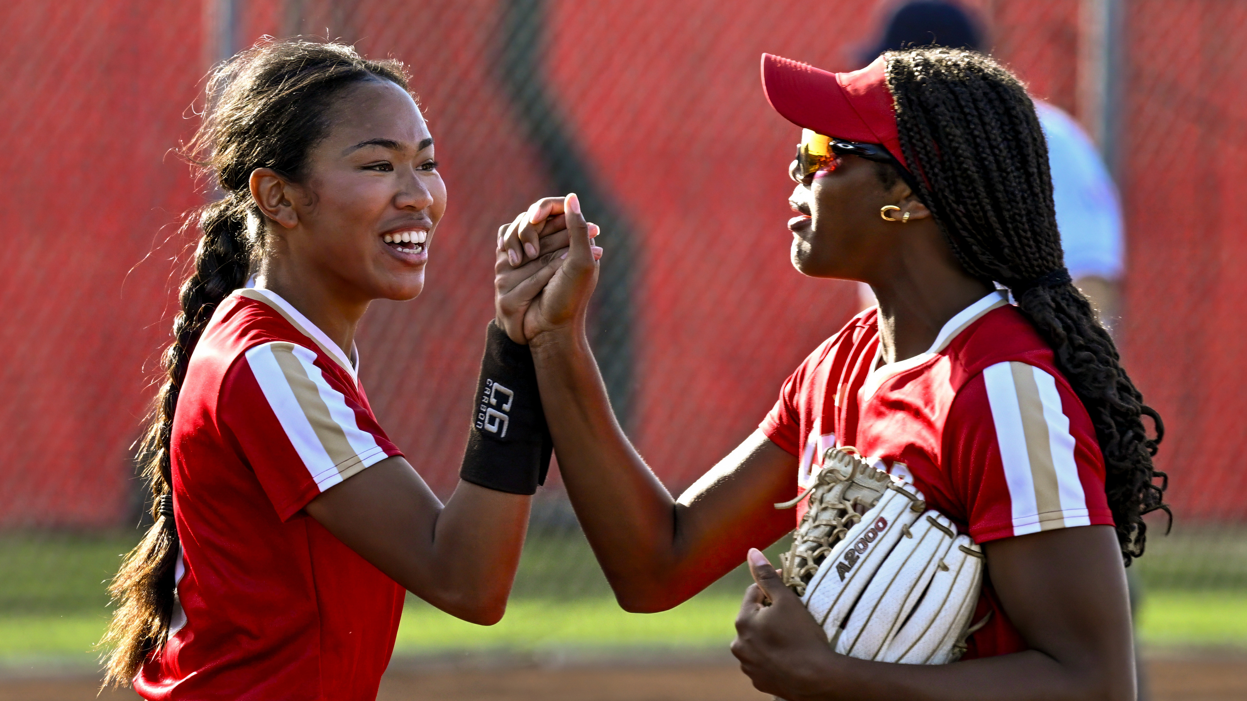 Pitcher Brianne Weiss (9), left, and Kai Minor (2) of Orange Lutheran celebrate after defeating Canyon in the quarterfinals of the CIF-SS Division 1 softball playoffs at Orange Lutheran High School in Orange on Thursday, May 9, 2024. (Photo by Leonard Ortiz, Orange County Register/SCNG)