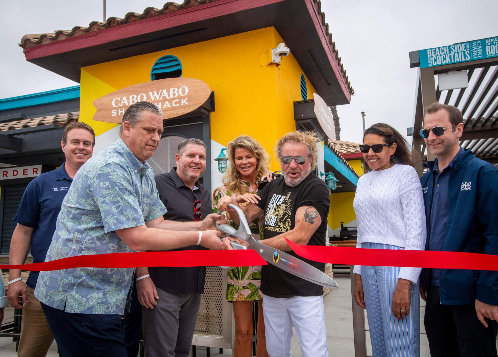 Sammy Hagar and his wife Kari were joined by members of the Huntington Beach city council and Kamran Enayat of The Waterfront Beach resort to cut the ribbon. Officially opening the Cabo Wabo Sand Bar.Sammy Hagar, appeared at the Cabo Wabo Sand Bar in Huntington Beach to commemorate its opening and have a ribbon cutting with The Waterfront Beach Resort on Friday May 17, 2024 (Photo by Michael Goulding, Contributing Photographer)