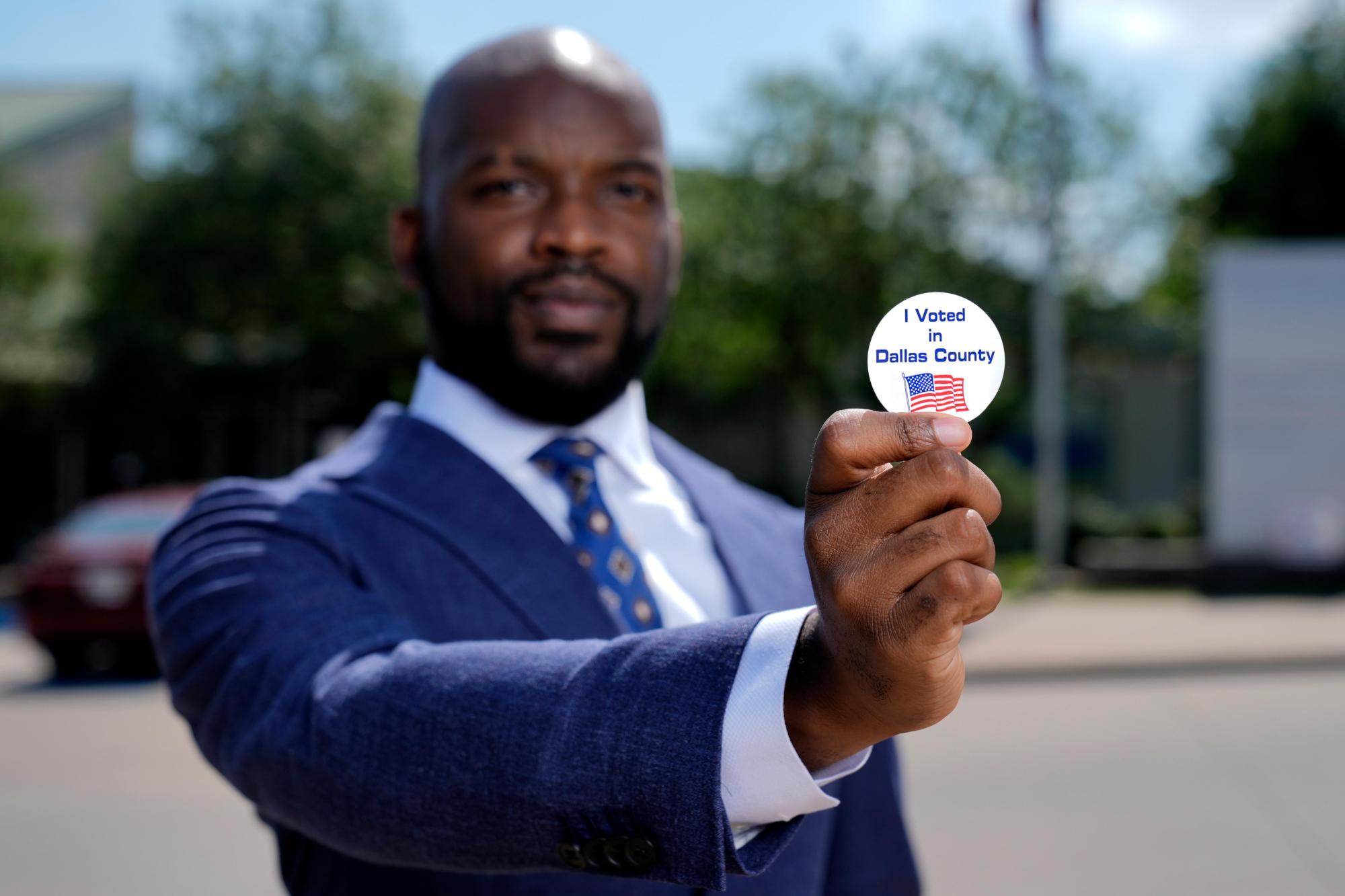 Abdul Dosunmu, the founder of the Young Black Lawyers Organizing Coalition, poses for a photo outside a voting location in Dallas, Monday, April 29, 2024. (AP Photo/Tony Gutierrez)