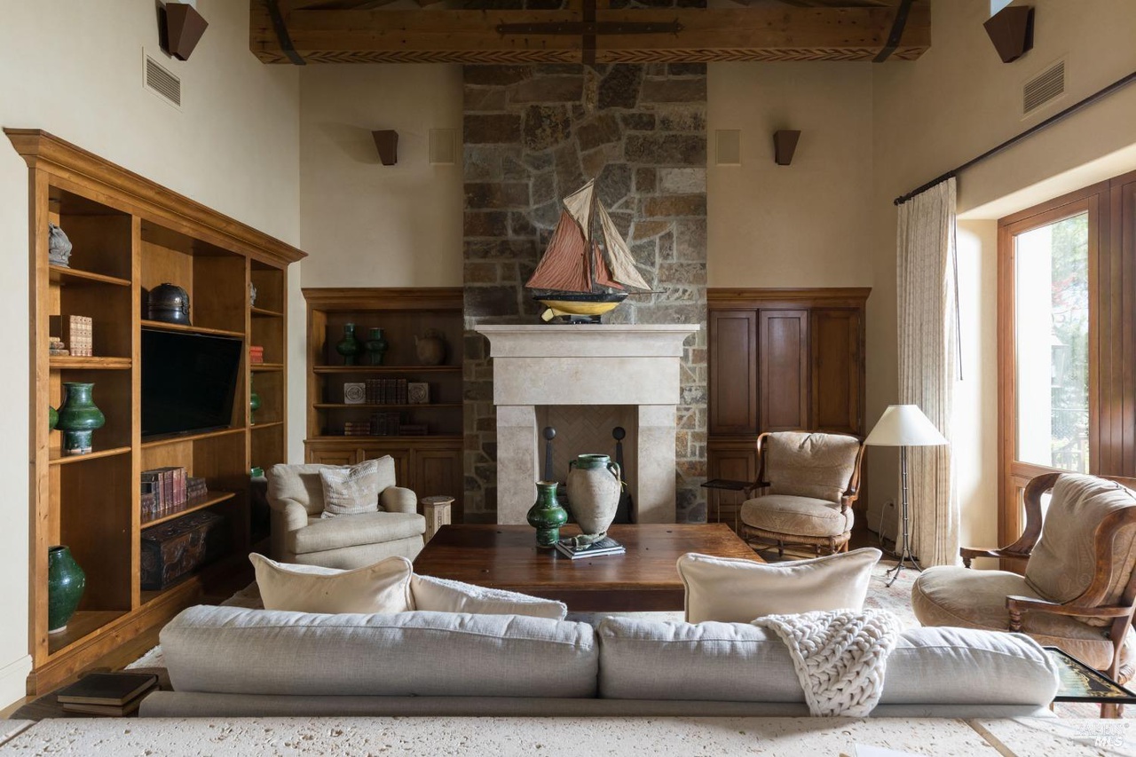 Living room with a stone fireplace.