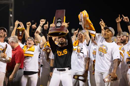 Tennessee coach Tony Vitello, center, hoists the national championship trophy following his team’s 6-5 victory over Texas A&M in Game 3 of the College World Series finals on Monday night in Omaha, Neb. (AP Photo/Rebecca S. Gratz)
