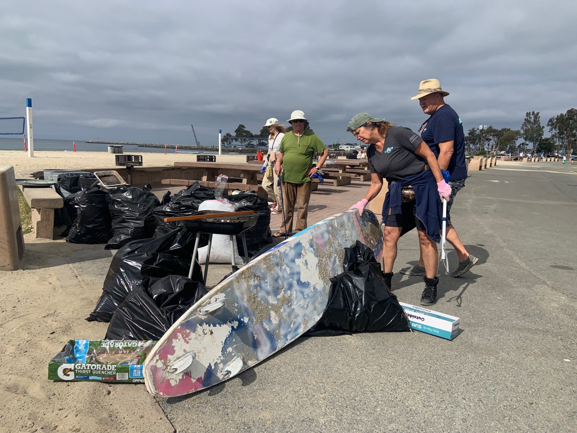 Volunteers with the Doheny Longboard Surfing Association help haul away trash left behind by Fourth of July revelers on July 5, 2022 at Doheny State Beach in Dana Point. (Photo by Laylan Connelly/SCNG)