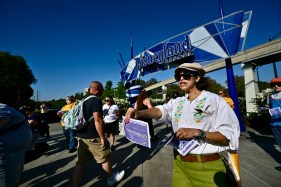 Disney cast members asked arriving theme park visitors to sign a petition in support of union contract negotiations seeking fair wages.