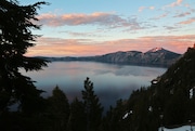 The sun sets over Crater Lake National Park, seen from Rim Village on the south side of the caldera. 