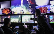 Scientists on board the research vessel R/V Atlantis observe a video and data feed from a robotic submersible diving at the Axial Seamount, an underwater volcano off the Oregon coast. The June 2024 dive allowed the scientists to gather additional information to help predict when the volcano might erupt next.