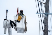 Utility workers, contracted out through Portland General Electric, work to repair power outages near SE 82nd Ave. and Division St. Sunday, Jan. 14, 2024. 