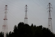 Three high voltage transmission towers, located just south of Sauvie Island, span the Willamette river in Portland, Oregon.