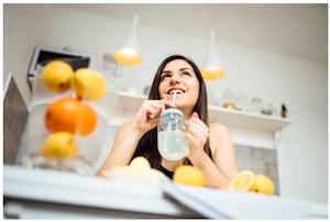 woman drinking lemon juice with a straw