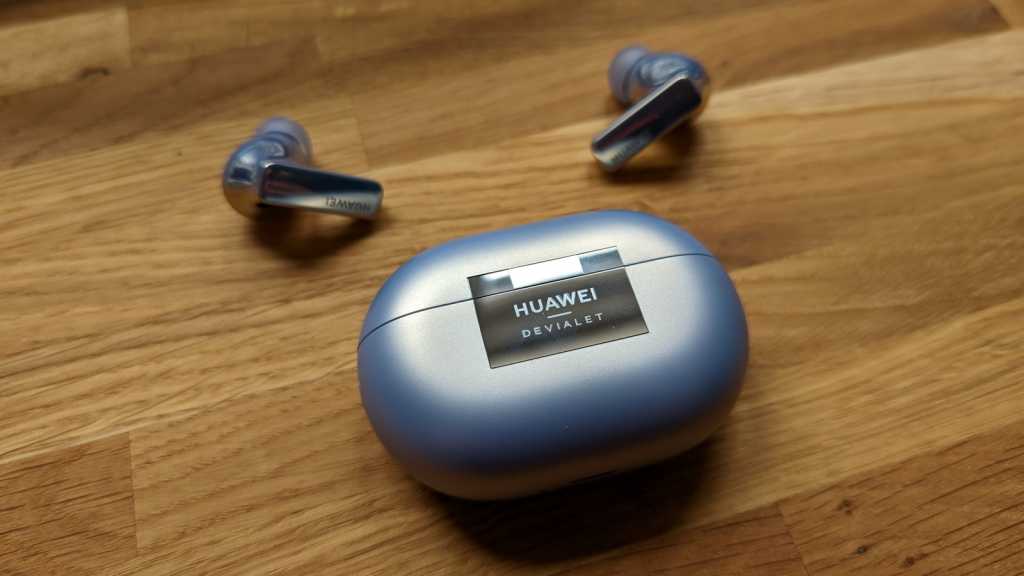 Earbuds and case on desk