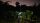 A Starlink satellite mounted on a wooden post in a dark, outdoor landscape, surrounded by trees, with a twilight sky in the background.