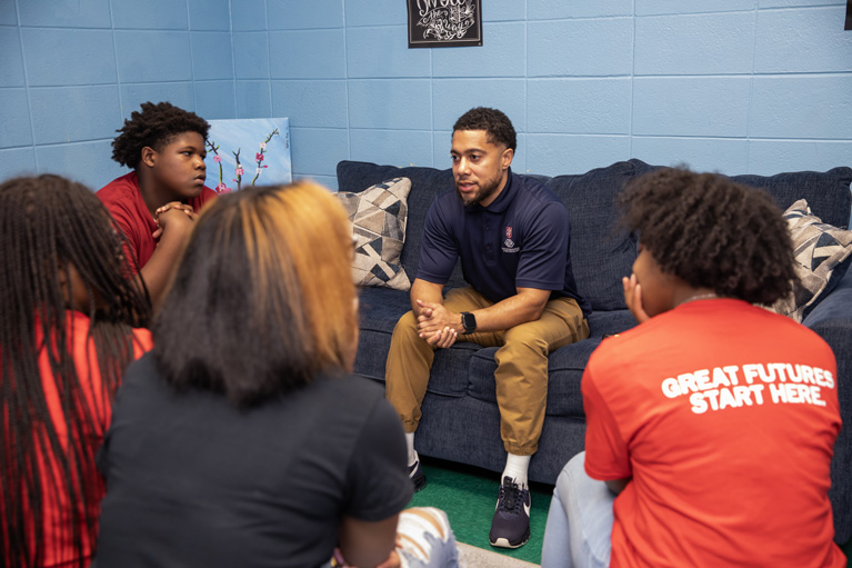 Youth Development Professional talking to Club kids